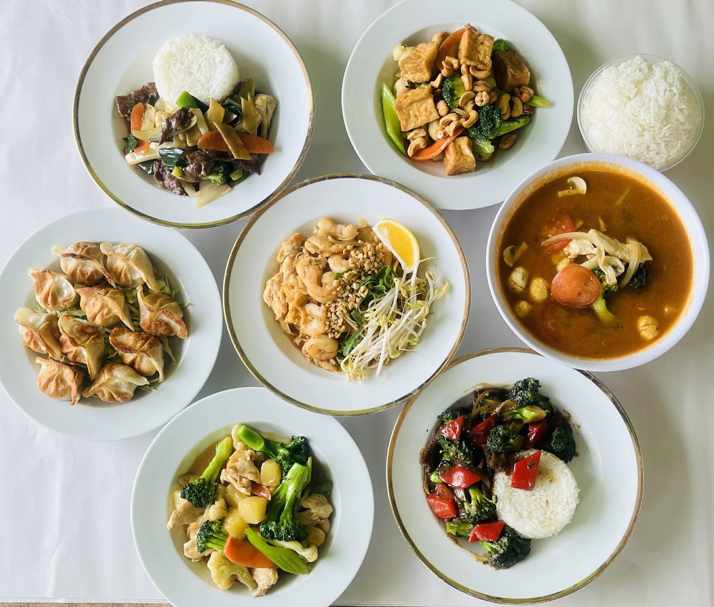 A spread of Chinese dishes with rice, curry and stir-fried vegetables