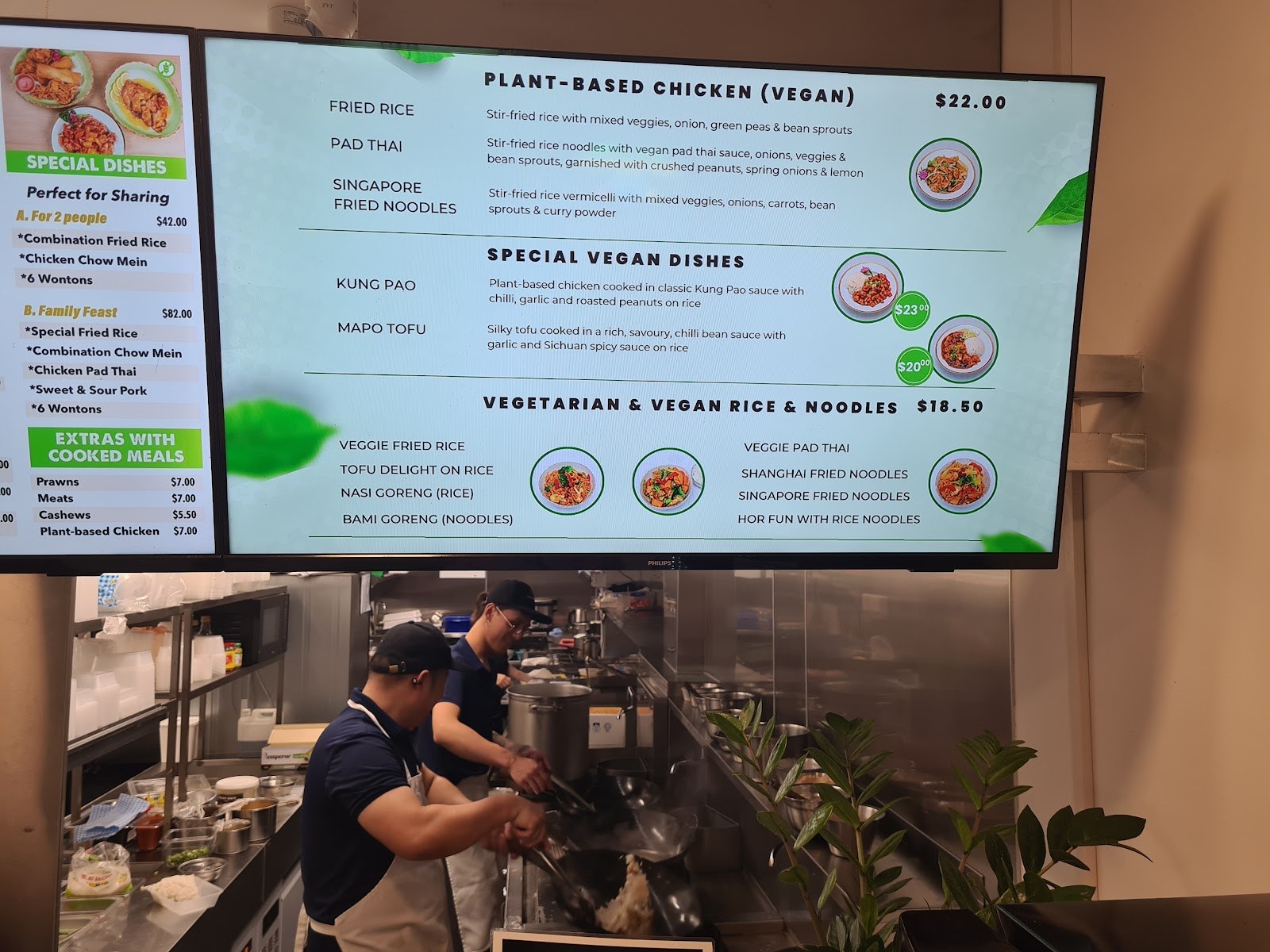 In-store board listing plant-based chicken, vegan noodles and special vegan dishes